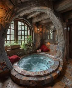 an indoor hot tub in the middle of a room with stone walls and arched windows