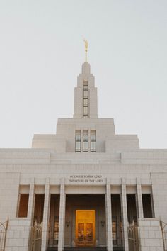 a large building with columns and a clock on top