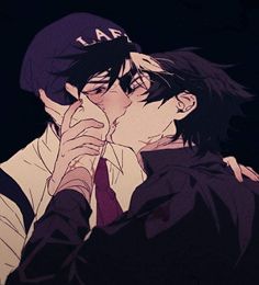 two people kissing in the dark with one holding his face to his other's mouth