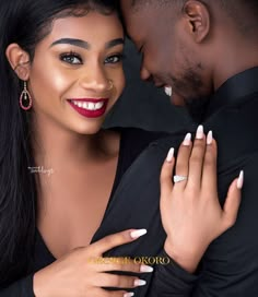 a man and woman embracing each other with their hands on the chest, both wearing matching rings