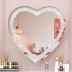 a heart shaped mirror with lights on it