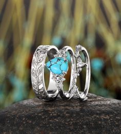 ITEM DESCRIPTION ✦Presenting our Couples Promise Ring set, a stunning representation of love and commitment.  The women's ring features a breathtaking 6x8mm pear-shaped natural mint blue turquoise as the main stone, beautifully complemented by shimmering moissanite side stones. The design is encased in a whimsical twig leaf floral setting, adding an organic and enchanting touch. For the men's band, enjoy a full eternity design featuring a twig leaf pattern, enhanced with intricate milgrain detai Silver And Turquoise Engagement Ring, Promise Ring In Turquoise Sterling Silver, Turquoise Sterling Silver Jewelry For Promise, Bohemian Stackable Wedding Jewelry, Turquoise Three Stone Ring As A Gift, Turquoise Three Stone Ring For Gift, Turquoise Vintage Promise Ring, Bohemian Turquoise Ring For Promise, Bohemian Round Promise Jewelry