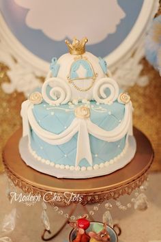 a blue and white cake sitting on top of a table