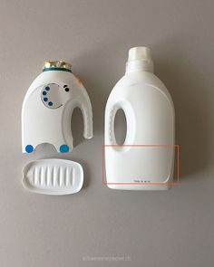 an elephant shaped bottle opener next to a white container with a toothbrush on it