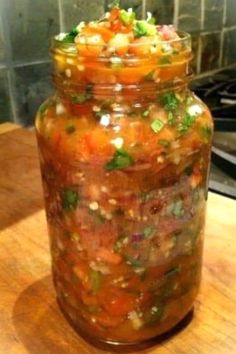 a jar filled with food sitting on top of a wooden table