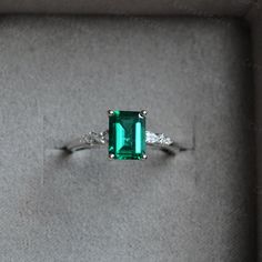 Breathtaking minimalist style green emerald ring, with a 1.2ct emerald in the middle, with a pear stone and two round stone on each side, simple but elegant design, can also wear with different bands, to make a unique match, beautiful and special gift for someone you loved or for yourself, we all worth beautiful items. ❥Details: Material: Solid 14K Gold Main Stone: 1.25ct Lab Created Emerald Cut: Emerald Side Stone: CZ/Moissanite CSG076 See other gold items in our shop: https://www.etsy.com/shop Green Emerald Jewelry For Proposal, Elegant Green Pear-shaped Rings, Green Emerald Ring With Prong Setting In Pear Shape, Green Emerald Ring With Accent Stones For May Birthstone, White Gold Emerald Promise Ring, White Gold Emerald Ring For Proposal, Green Emerald Birthstone Ring With Center Stone, Pear-shaped Green Emerald Ring With Prong Setting, Proposal White Gold Emerald Ring