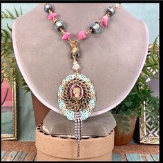 Bj Adorned Crown Assemblage Statement Necklace Original Design Necklace Assembled Using A Vintage Glass Intaglio Cameo Mounted On A Gold Tone And Teal Filigree Background. I’ve Assembled The Chain With A Vintage Natural Patina Brass Hand Charm Holding The Pendant And Hung From Wire Wrapped Pink Howlite Stone Beads And Faceted Glass Beads. Measures 21” Long With An Asymmetrical Side Closing Hook And Eye Clasp Pendant Measures 2” Assemblage Jewelry Is Made Using Pre-Loved Pieces Of Jewelry, Toys, Artisan Pink Beaded Necklace For Festivals, Elegant Pink Necklaces For Festivals, Pink Handmade Beaded Necklaces, Elegant Pink Beaded Necklace For Festival, Unique Pink Beaded Necklace For Party, Pink Bohemian Beaded Jewelry, Pink Bohemian Necklace For Party, Pink Bohemian Beaded Necklace For Party, Stone Bead Necklace