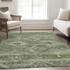 a living room area with two chairs and a rug in front of a large window