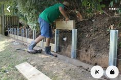 a man is working on some kind of fence