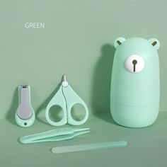 a green bear shaped container next to scissors and other items