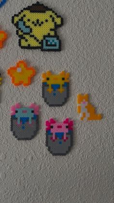 some pixelated objects are on the wall next to each other in different colors and shapes