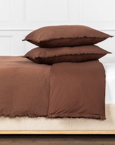 three brown pillows stacked on top of each other