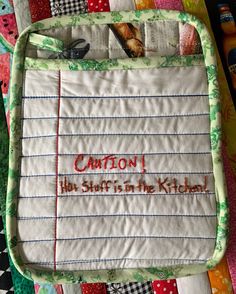 a quilted placemat with the words caution written on it