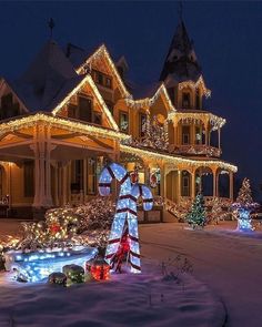 a large house covered in christmas lights and decorations