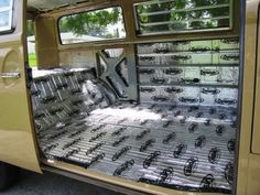 the inside of a van with its door open and windows covered in plastic wraps