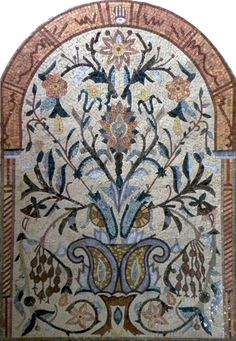 an intricately designed mosaic with flowers and leaves on it's side, in the middle