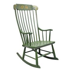 a green rocking chair with flowers painted on the back and seat, against a white background