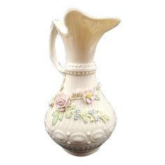 a white vase with flowers painted on the bottom and sides, sitting against a white background