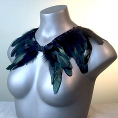 "This is a luxurious custom piece created using black rooster feathers and satin ribbon. This simple shawl design wraps elegantly around your neck and shoulders and ties in the front. You can even opt to wear this around your waste if desired. There are many options. Size is approximately 2' long by about an average of 7\" wide not including the ribbon tie. Perfect for Fairy Festivals, Fanciful Halloween Costumes, Masquerade Balls, Cosplay Events, Stage Performances, Dance Accessory, Easter; Eve Viking Halloween Costume, Vikings Halloween, Shoulder Shrug, Feather Collar, Fairy Festival, Black Fascinator, Rooster Feathers, Feather Hair Clips, Dance Accessories