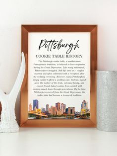 the pittsburgh cookie table history is displayed in front of a white vase and silver candle holder