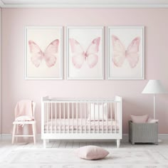 a baby's room with pink walls and white furniture