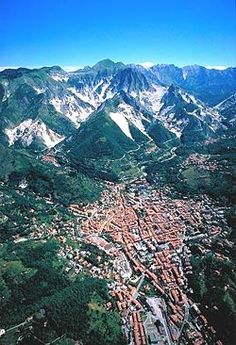 an aerial view of a city surrounded by mountains