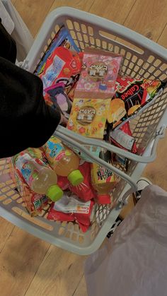 a shopping basket filled with candy and snacks