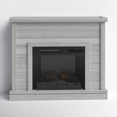 a white fireplace with some blankets on it's mantle and the fire is lit