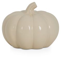 a white ceramic pumpkin sitting on top of a table