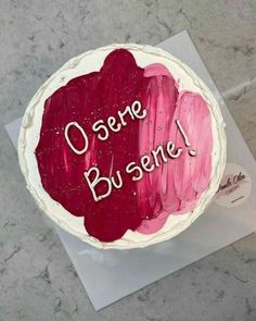 there is a cake that has been decorated with red and pink icing on it