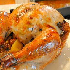 a roasted turkey with potatoes and carrots on a white plate