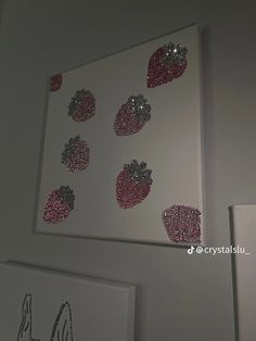 the wall is decorated with red and silver sequins, which are attached to white canvases