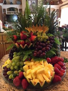 a platter filled with lots of fruit on top of a table