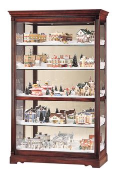 a wooden display case filled with lots of toy houses and trees on top of snow covered ground