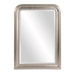 a silver framed mirror on a white wall