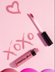 some lipsticks are laying next to each other on a pink background with the word xoxo written in it