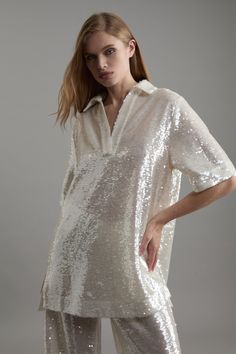 Elevate Your Every Day Wardrobe In Our Tunic Dress, With A Relaxed Silhouette, As Well As A Unique Sheer, Sparkling Sequin Fabric, And A V Neckline With A Collar Accent. The Sheer Detailing Makes For A Dynamic Mini Dress Option. Style It With Tailored Trousers Or Go For Bare Legs, As Well Strappy Heels For An Elevated Evening Look. Sequin Collared Tunic Dress High Quality, Sparkling Sequin Fabric Flattering Relaxed Silhouette Longline Shirt Design V Neckline Classic Collar Accent Mini Length Petite Work Outfits, Petite Wedding Guest Dresses, Dress Leather Boots, Winter Coat Dress, Outfits Petite, Plus Size Workwear, Fitted Tunic, Sequin Shirt, Petite Coat