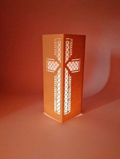 a paper box with a cross cut out of it