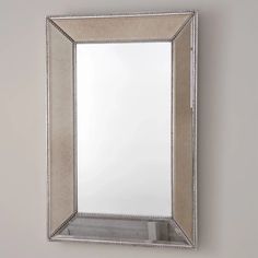 a mirror hanging on the wall above a sink