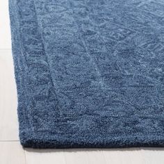 a blue rug on the floor in a room