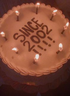 a birthday cake with lit candles on it that says, i miss you 200th