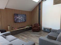 a living room filled with furniture and a flat screen tv mounted to the side of a wall