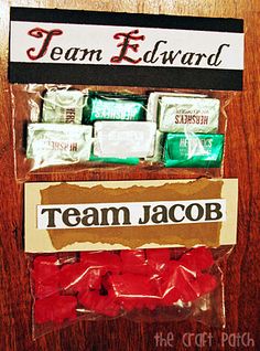 some candy wrapped in plastic on top of a wooden table next to a sign that says team edward