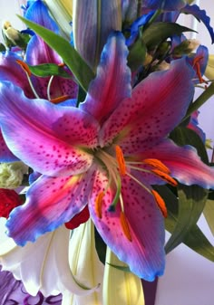 a vase filled with purple and red flowers