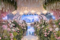 an elaborately decorated stage with flowers and chandeliers