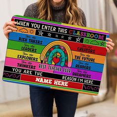 a woman holding up a sign that says when you enter this classroom