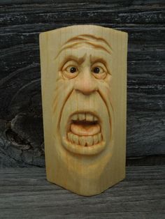 a wooden block with a carved face on it