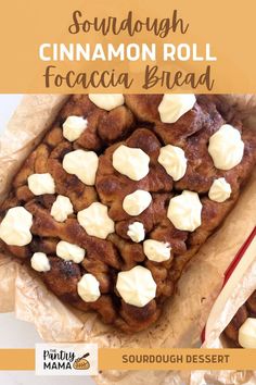 a close up of food on a piece of wax paper with text overlay that reads sourdough cinnamon roll focacia bread