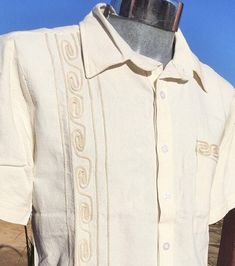 CLASSIC & AUTHENTIC GUAYABERA   ELEGANT STYLE GUAYABERA 100% FINE COTTON Feature an elegant and intricate Tulum style embroidery,  One front  unique embroidery Short Sleeve with design Classic collar Button-down Dress Shirt 100 % Fine Cotton  Pre-washed Care instructions: This beautiful item was handmade. To maintain the quality of the work, we recommend hand wash in cold water and air drying. Guayabera Shirt, Cotton Wedding, Men Closet, Gold Silk, Shirt Dress Casual, Front Bottoms, Silk Embroidery, Embroidery Dress, Silk Thread