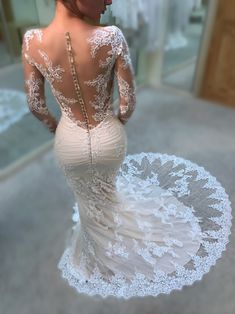 the back of a woman's wedding dress, with an intricate lace design on it